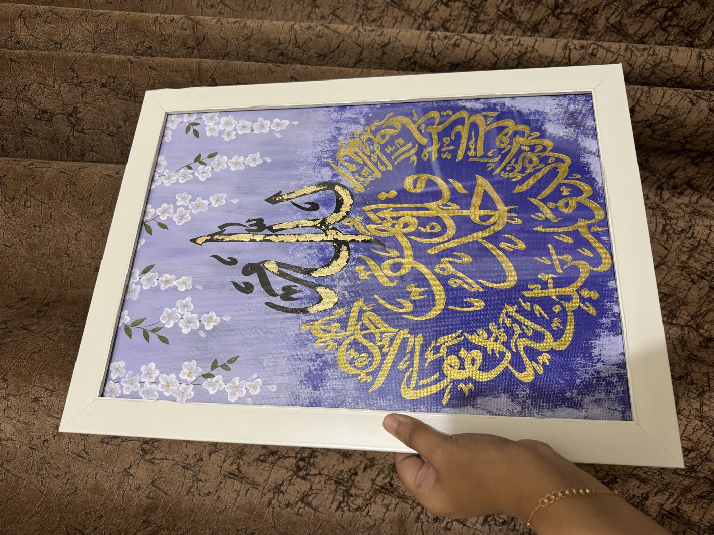 Gold thuluth roundel over violet washes with white blossom branches, white frame