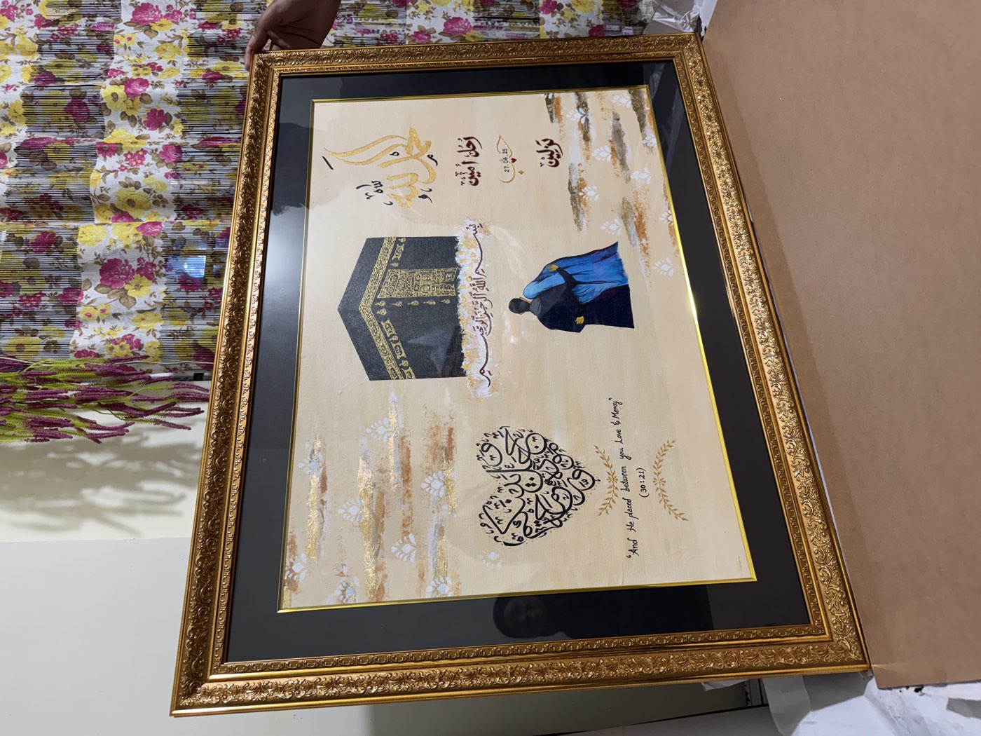 Wedding commission: a couple stands before the Kaaba beneath gold calligraphy, in an ornate gold frame