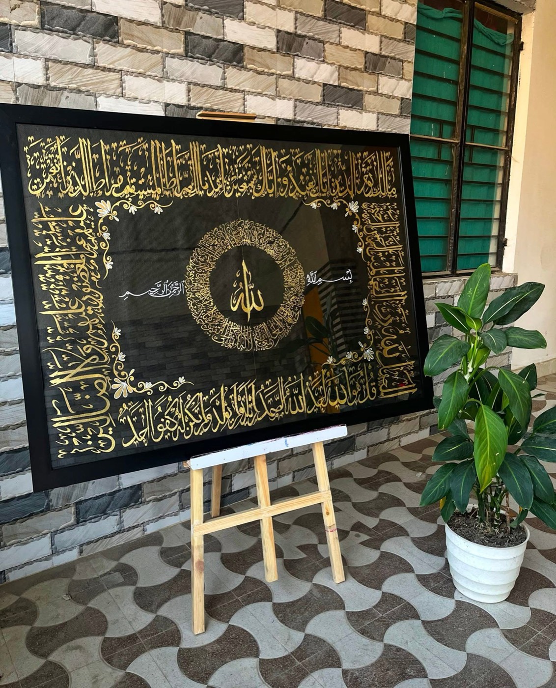 Large black and gold piece with central roundel and border bands in the style of the Kiswah