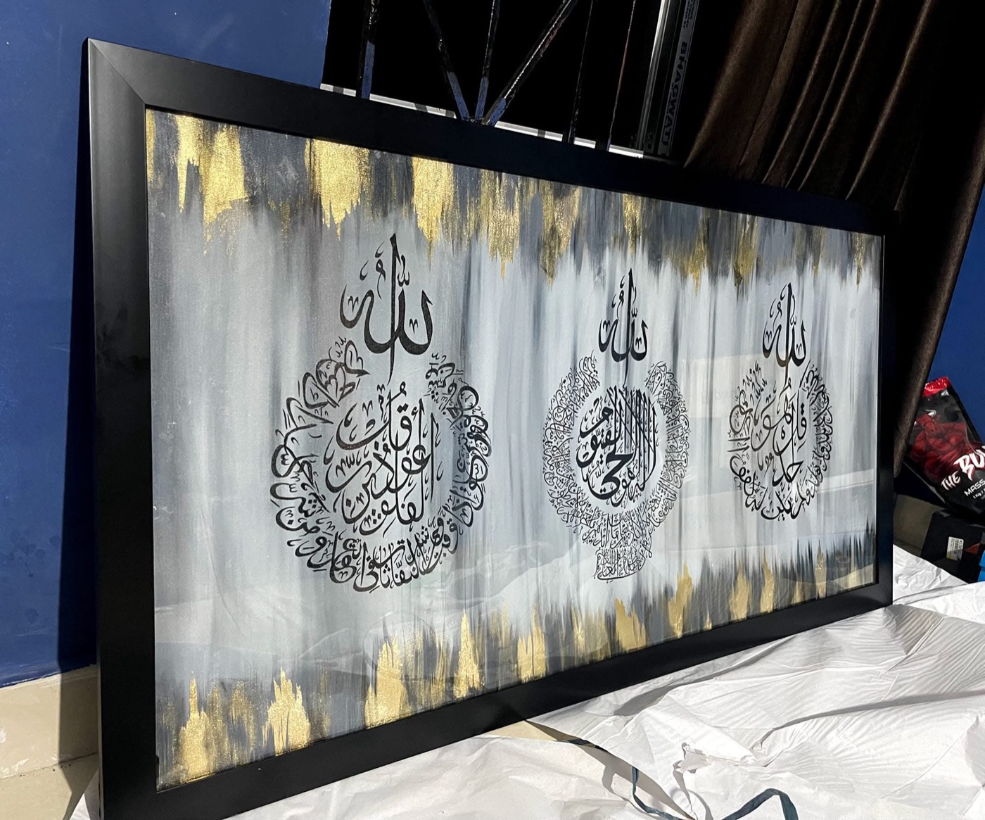 Wide triptych of three black calligraphy roundels on grey washes with gold streaks