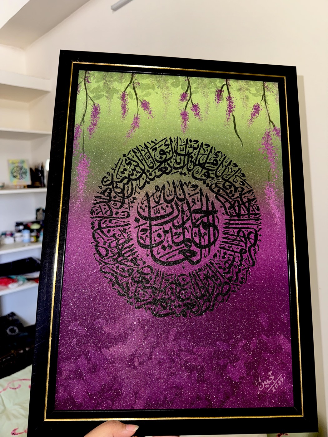 Circular calligraphy over a green-to-violet ombre ground with wisteria vines, glazed black frame